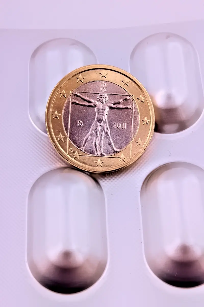 gold round coin on white surface